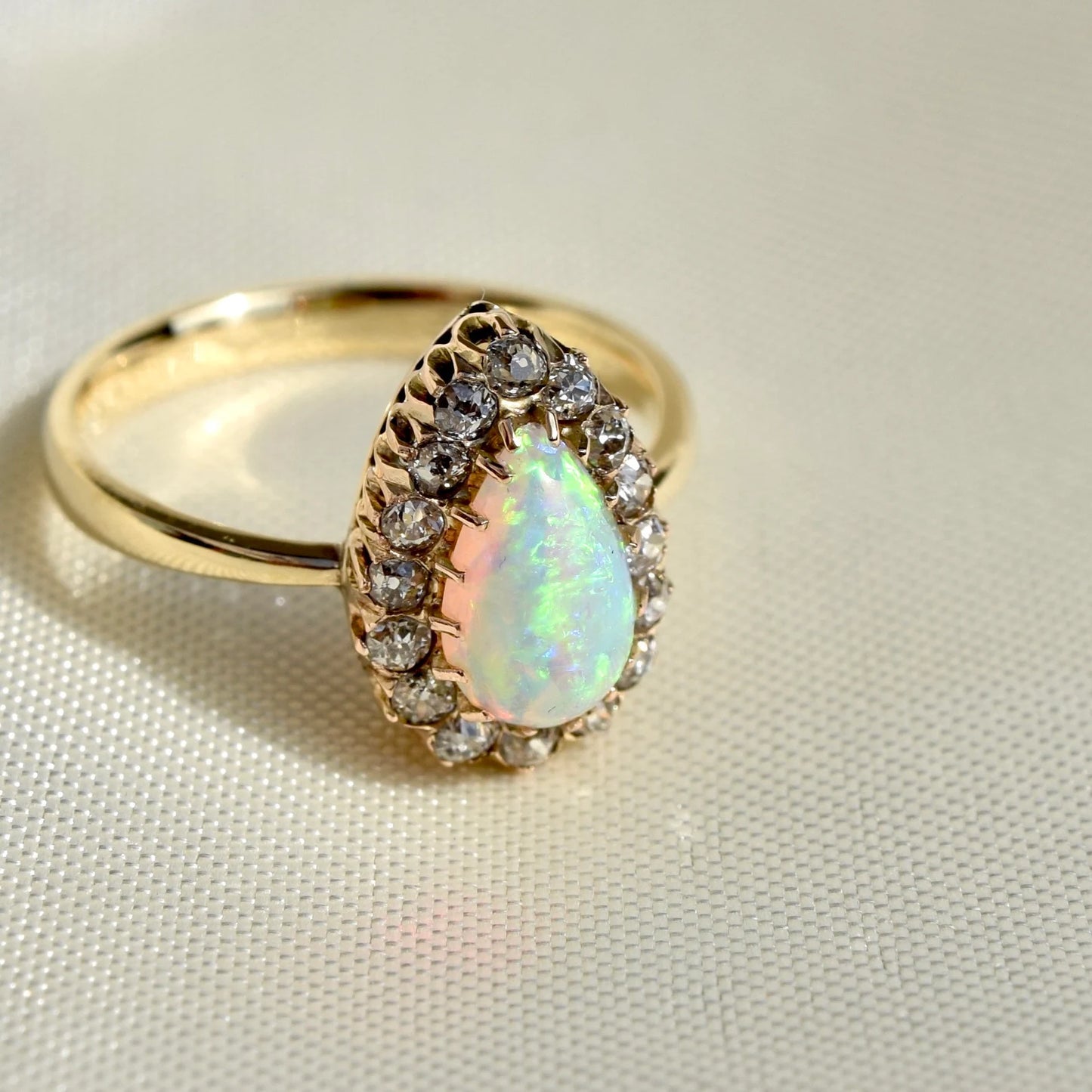 Opal pear and 0.32ct old mine cut diamond ring